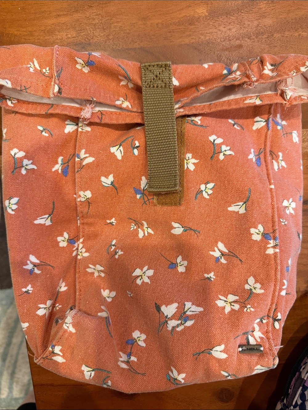 O’Neill Canvas Roll-Top Lunch bag in Rust floral design